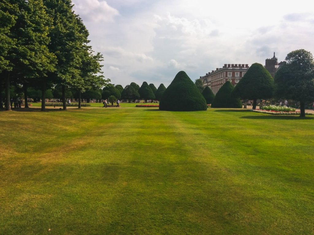 pexels-photo-227391 Beautiful landscaped garden with topiary near a historic mansion, under a cloudy sky.